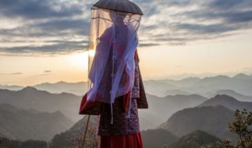 Vue sur les montagnes du Japon : une femme senior, habillée d'une tenue traditionnelle et un voile.