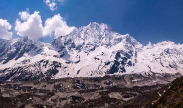 Neige montagne Népal : il y a de la végétation et plus haut on voit des montagnes enneigées.