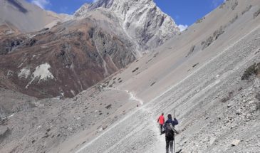 Sentier randonnée-rocheux Népal : deux randonneurs qui traversent des sentiers. Il se dirige vers les montagnes.