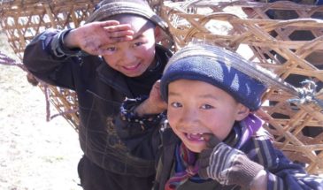 Trekking Everest : il y a deux enfants qui portent avec leur tête un grand panier.